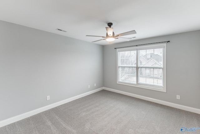 spare room featuring carpet flooring and ceiling fan