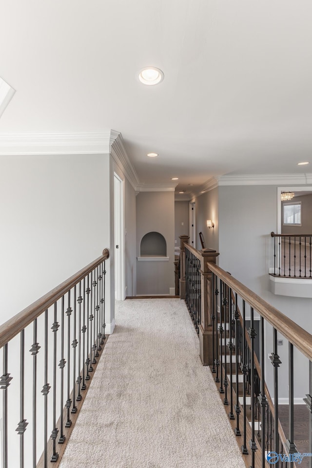 hallway featuring crown molding and light carpet