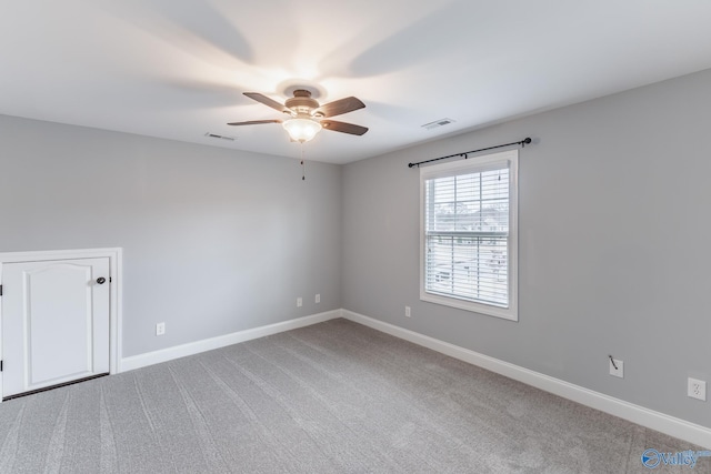 carpeted empty room featuring ceiling fan