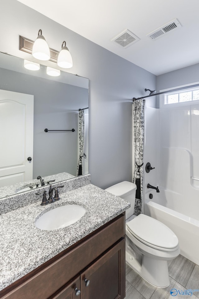 full bathroom with vanity, wood-type flooring, shower / bath combo, and toilet