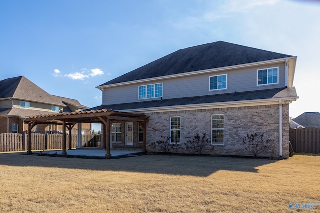 back of property with a lawn, a pergola, and a patio