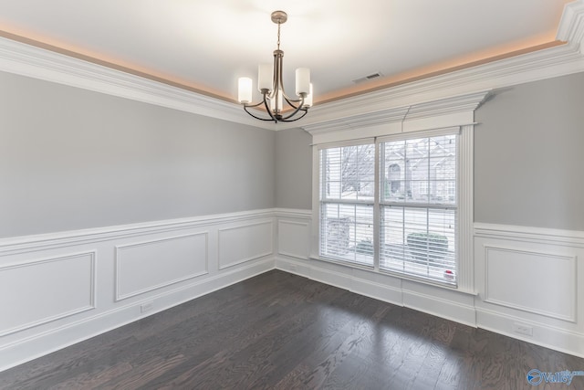 unfurnished room with a chandelier and dark wood-type flooring