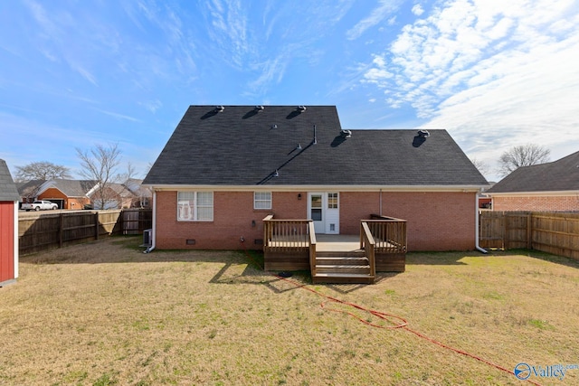 rear view of house featuring crawl space, a lawn, and a fenced backyard