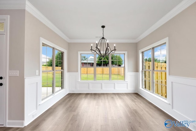 210 Lyndon Cove Rd, Huntsville, AL 35811 - unfurnished dining area featuring a chandelier, wood finished floors, wainscoting, a decorative wall, and ornamental molding