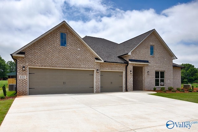 210 Lyndon Cove Rd, Huntsville, AL 35811 - view of front of home with brick siding, concrete driveway, a shingled roof, and an attached garage