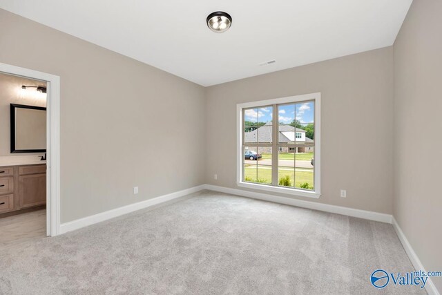 210 Lyndon Cove Rd, Huntsville, AL 35811 - unfurnished bedroom featuring light carpet and connected bathroom