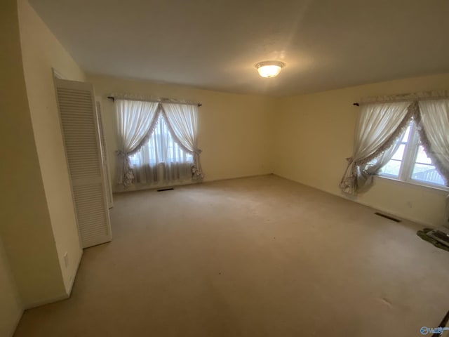 empty room featuring light colored carpet