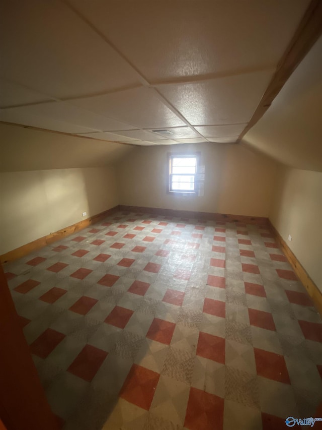 additional living space featuring lofted ceiling