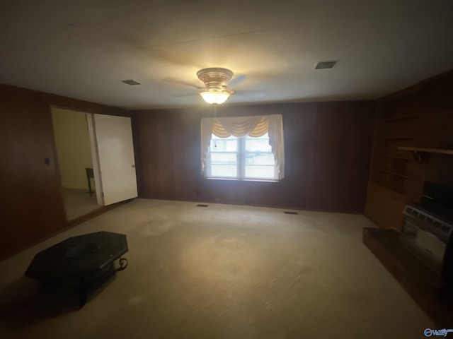 unfurnished living room with carpet floors and ceiling fan