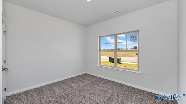 carpeted empty room featuring recessed lighting, visible vents, and baseboards