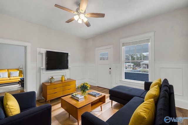 living room featuring hardwood / wood-style floors and ceiling fan