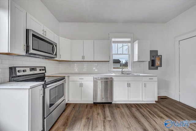 kitchen featuring stainless steel appliances and white cabinetry