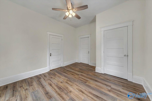 unfurnished bedroom featuring hardwood / wood-style flooring and ceiling fan