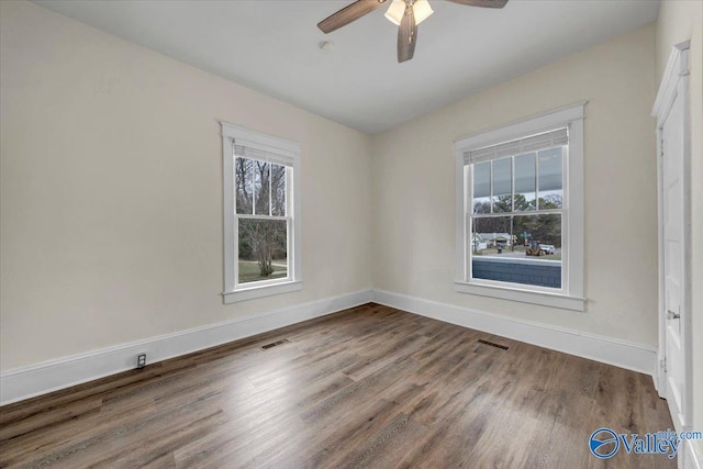 unfurnished room featuring wood-type flooring, a healthy amount of sunlight, and ceiling fan