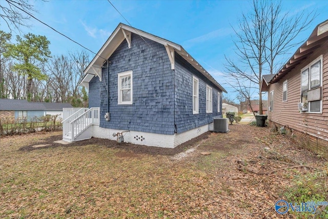 view of side of home with central AC