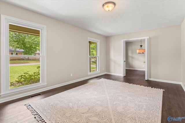 605 Holland Dr SW, Decatur, AL 35601 - empty room with dark wood-type flooring and baseboards