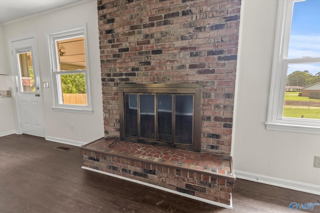 605 Holland Dr SW, Decatur, AL 35601 - detailed view of baseboards, wood finished floors, a fireplace, and ornamental molding