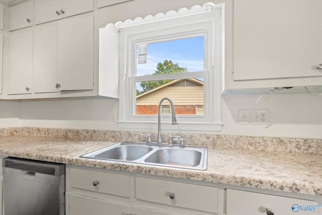 605 Holland Dr SW, Decatur, AL 35601 - kitchen with stainless steel dishwasher, a sink, light countertops, and white cabinets
