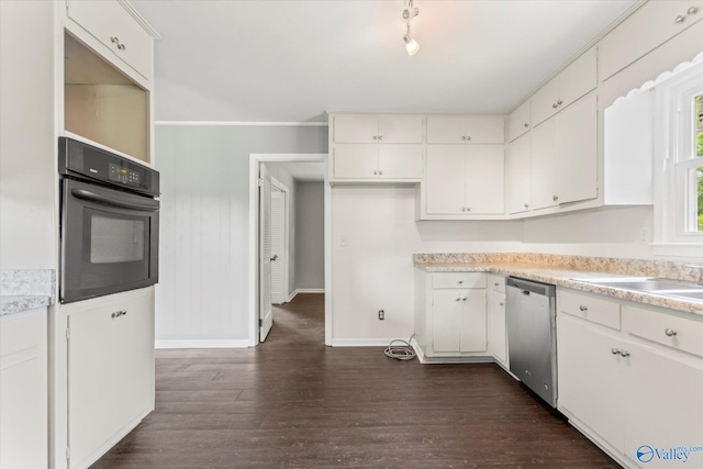 605 Holland Dr SW, Decatur, AL 35601 - kitchen with stainless steel dishwasher, black oven, dark wood-type flooring, baseboards, and white cabinets