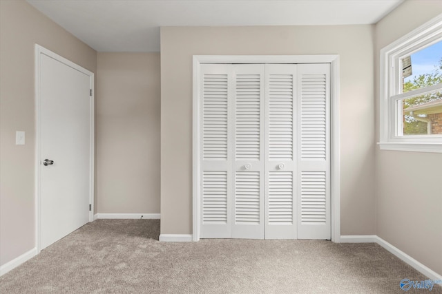 605 Holland Dr SW, Decatur, AL 35601 - unfurnished bedroom with carpet, a closet, and baseboards
