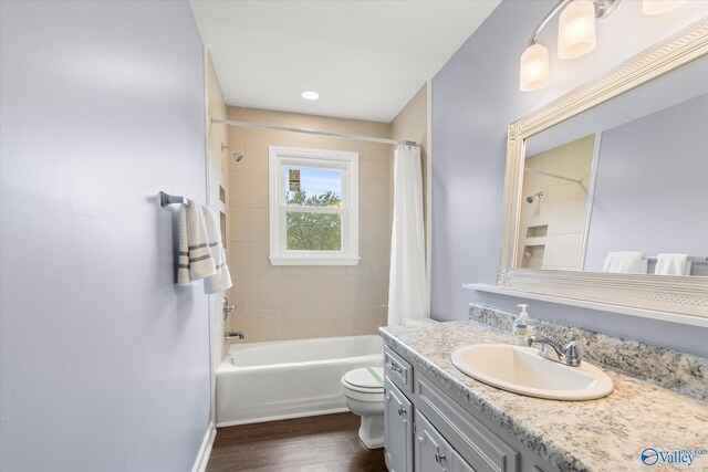 605 Holland Dr SW, Decatur, AL 35601 - bathroom featuring wood finished floors, vanity, shower / bath combination with curtain, and toilet