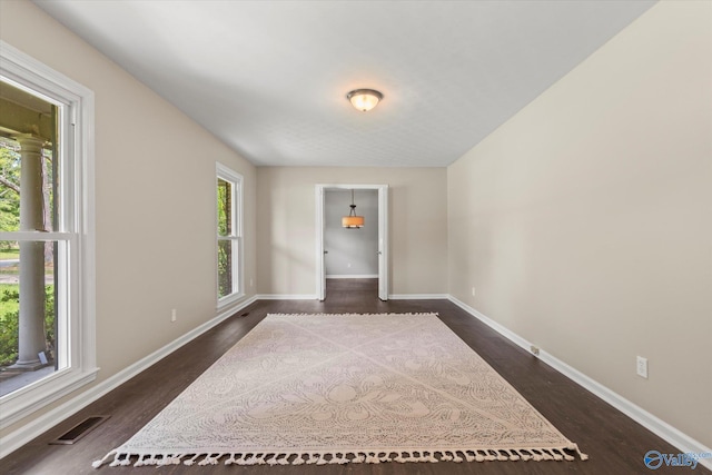 605 Holland Dr SW, Decatur, AL 35601 - empty room featuring dark wood-style flooring and baseboards
