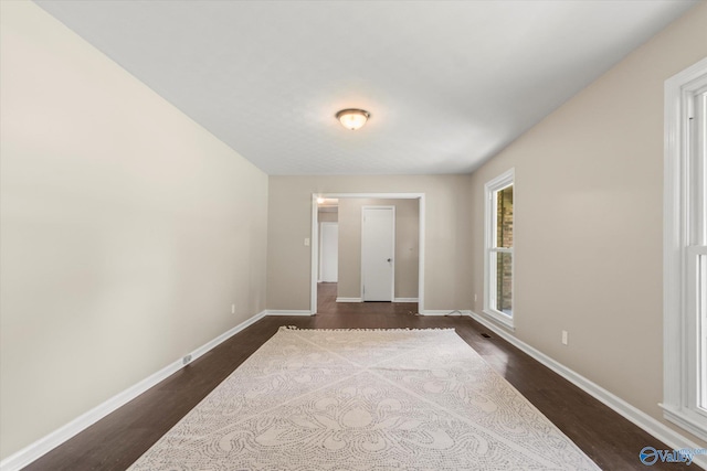 605 Holland Dr SW, Decatur, AL 35601 - empty room with dark wood finished floors and baseboards