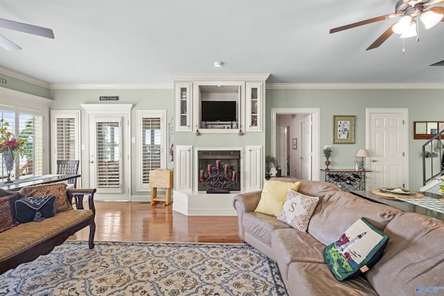 6468 Turtle Bay Way E, Athens, AL 35611 - living room featuring a ceiling fan, wood finished floors, ornamental molding, and a large fireplace