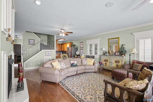 6468 Turtle Bay Way E, Athens, AL 35611 - living room with stairway, a ceiling fan, hardwood / wood-style flooring, baseboards, and crown molding