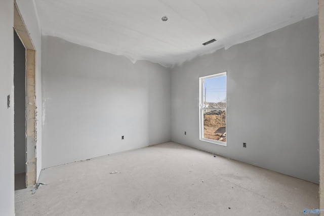 unfurnished room with visible vents