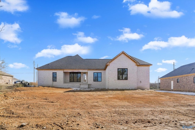 back of property featuring roof with shingles