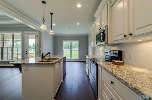 kitchen featuring ornamental molding, appliances with stainless steel finishes, a sink, and tasteful backsplash