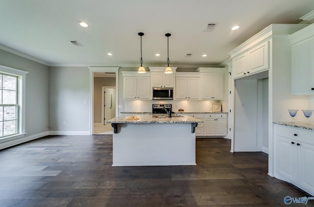 kitchen featuring stainless steel appliances, ornamental molding, white cabinetry, and light stone counters