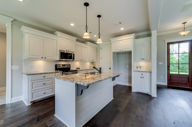 kitchen with a sink, white cabinetry, ornamental molding, appliances with stainless steel finishes, and dark wood finished floors