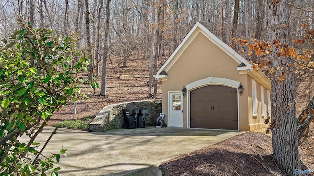 garage with concrete driveway