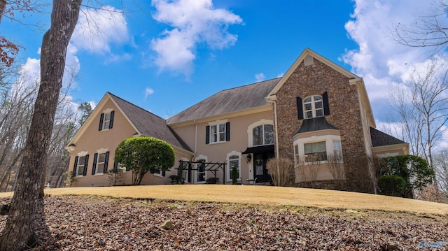 view of front of home with stucco siding and a front yard