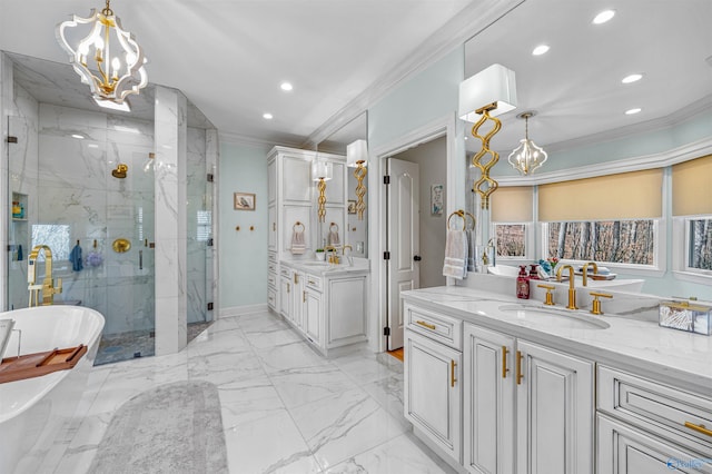 full bath with a sink, marble finish floor, a chandelier, and crown molding