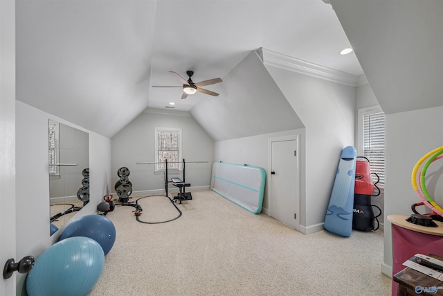 workout area featuring baseboards, carpet, ceiling fan, and vaulted ceiling