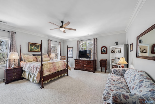 carpeted bedroom with ceiling fan, visible vents, baseboards, and ornamental molding