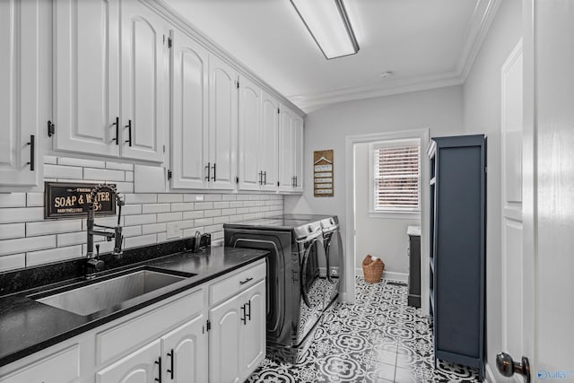 clothes washing area featuring light tile patterned flooring, cabinet space, ornamental molding, a sink, and washing machine and dryer