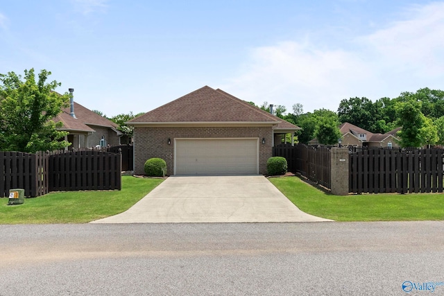907 Binding Br NW, Huntsville, AL 35806 - view of front facade featuring brick siding, driveway, and an attached garage