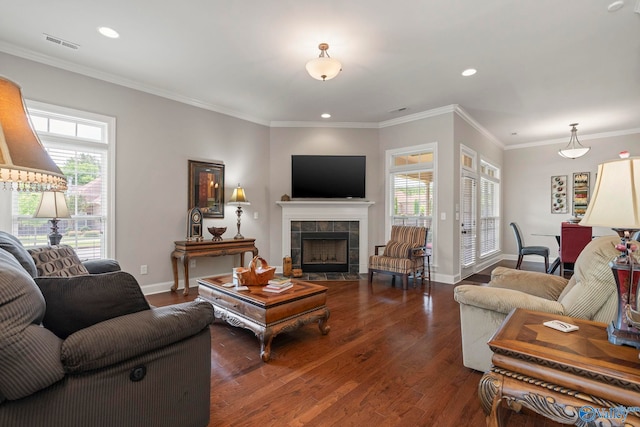 907 Binding Br NW, Huntsville, AL 35806 - living area with wood finished floors, a tiled fireplace, crown molding, and recessed lighting