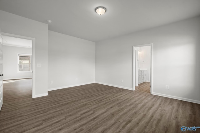 unfurnished room with dark hardwood / wood-style flooring