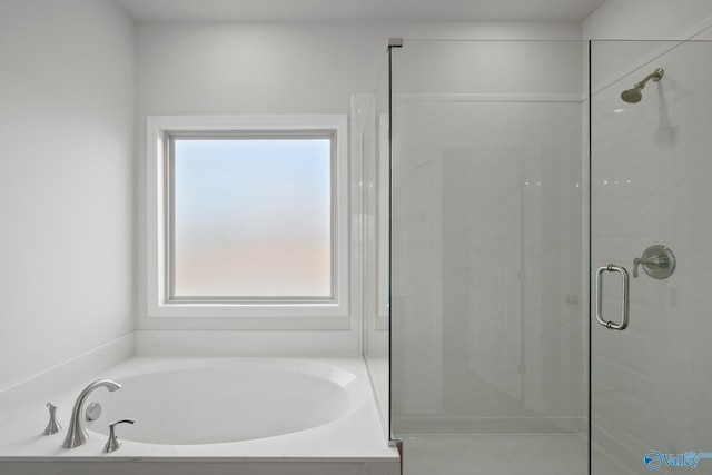 bathroom featuring shower with separate bathtub