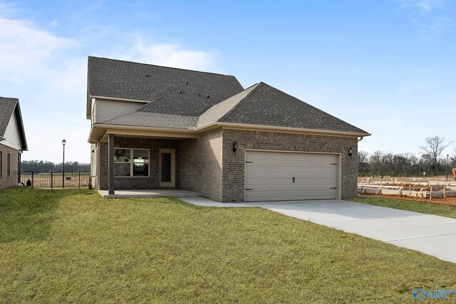 view of front of home featuring a front yard and a garage