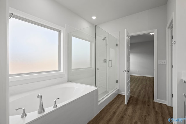 bathroom with hardwood / wood-style flooring, vanity, and independent shower and bath