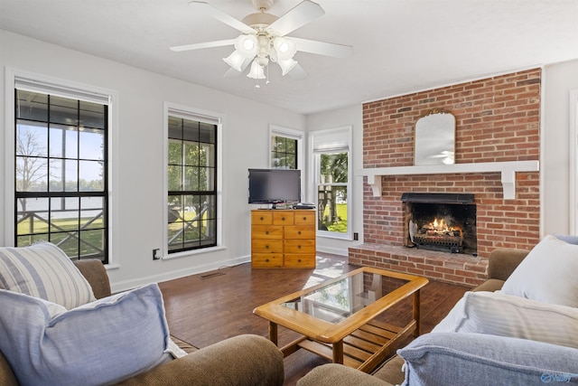 220 County Road 564, Leesburg, AL 35983 - living room featuring baseboards, a ceiling fan, a brick fireplace, and wood finished floors