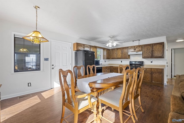 220 County Road 564, Leesburg, AL 35983 - dining room featuring baseboards, visible vents, a ceiling fan, and dark wood-style floors
