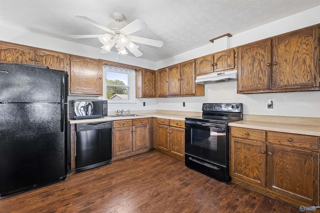 220 County Road 564, Leesburg, AL 35983 - kitchen featuring dark wood-style floors, a sink, light countertops, under cabinet range hood, and black appliances