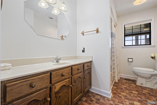 220 County Road 564, Leesburg, AL 35983 - bathroom with toilet, visible vents, baseboards, brick floor, and vanity